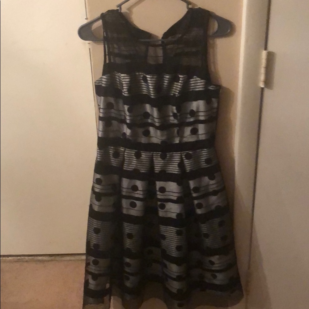 Black and white sleeveless polka dot dress.